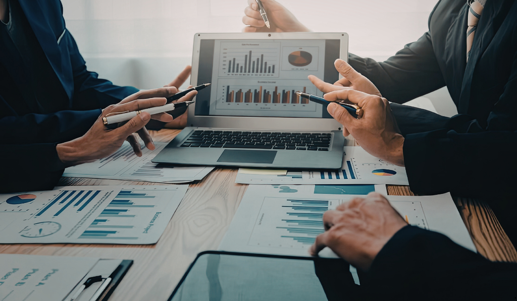 Business professionals reviewing charts and performance data, illustrating how Statistical Analysis for Six Sigma uses data-driven tools to evaluate process performance and guide improvement decisions.