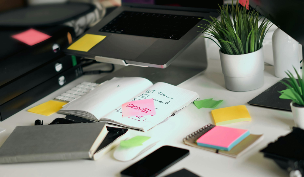 Organized workspace with notes and planning materials representing task analysis and workflow improvement using the MODAPTS work-measurement system.