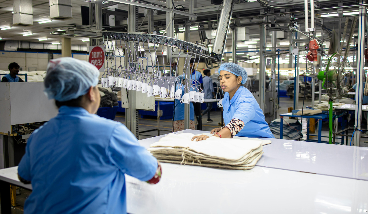 Workers handling materials on a production line, illustrating takt time vs. cycle time through the pace of work required to meet manufacturing demand.