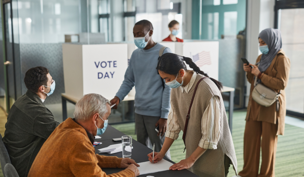 Voters and election workers at a polling station on voting day, illustrating the EVM election process and voter participation.
