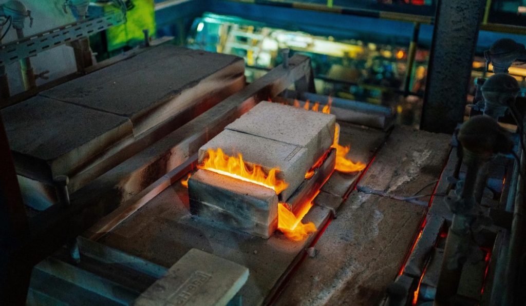 Industrial manufacturing equipment processing materials as part of a Rolled Throughput Yield workflow to maximize first-pass yield.