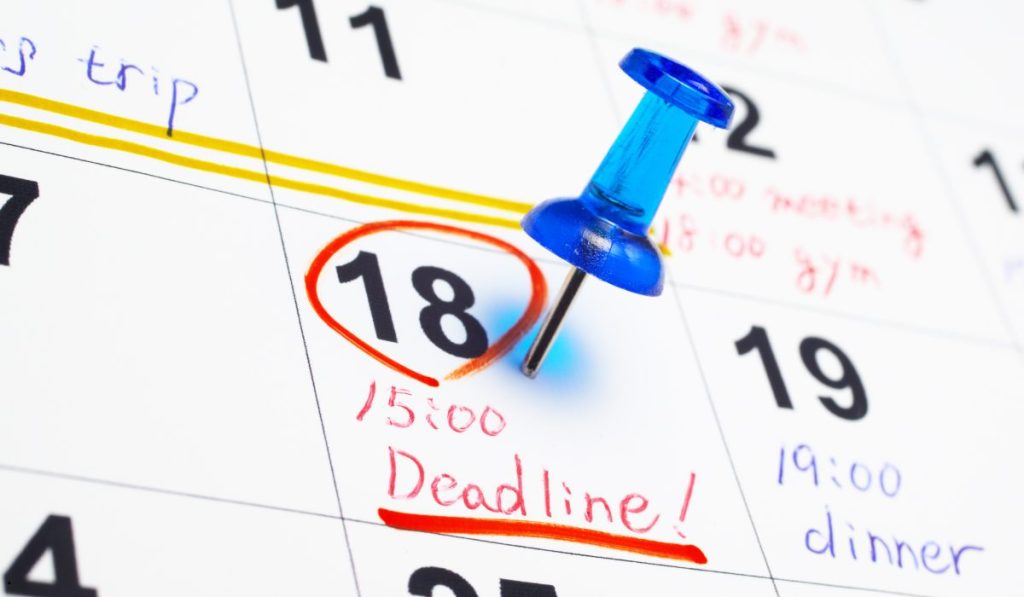 Calendar with a marked deadline representing turnaround time for project scheduling and timely task completion.