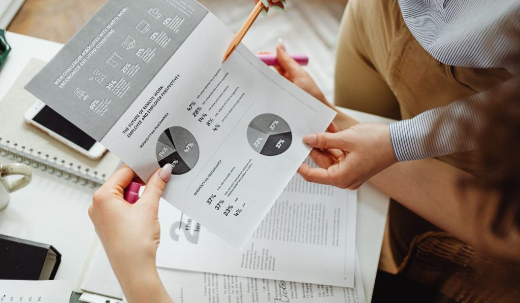 Business professionals reviewing statistical reports and charts related to Normal Probability Plot R data analysis and distribution assessment.