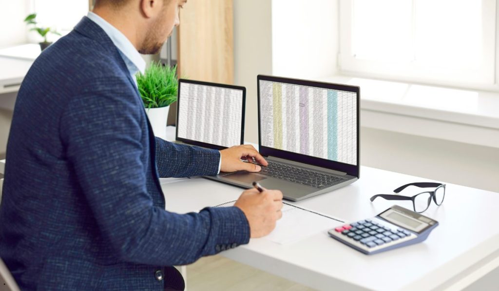 Business analyst reviewing spreadsheets for Pooled Standard Deviation Excel calculations and statistical data analysis.
