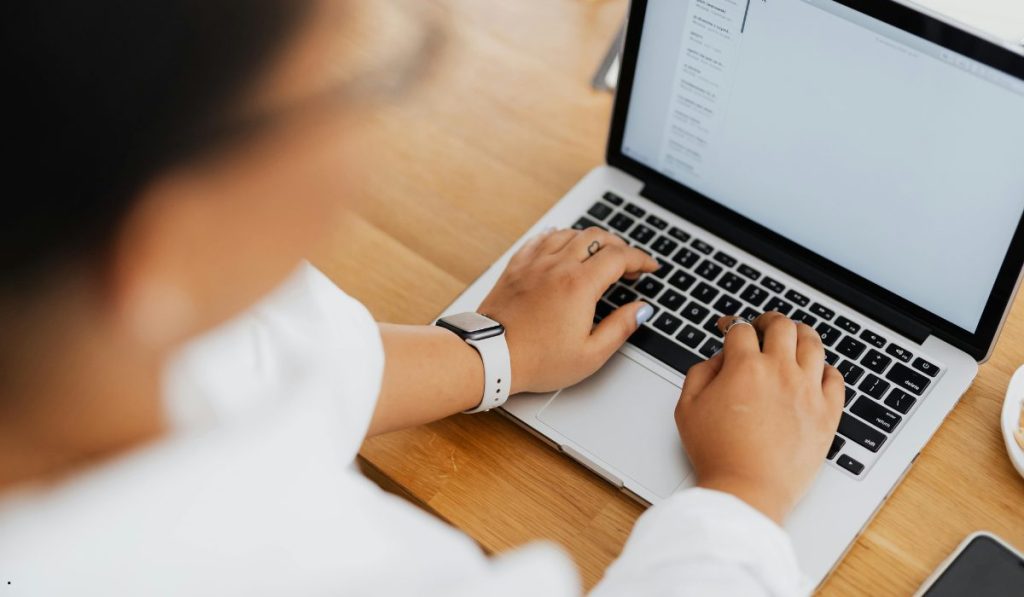 Professional using a laptop to prepare Probability Plot Excel calculations for data distribution analysis.