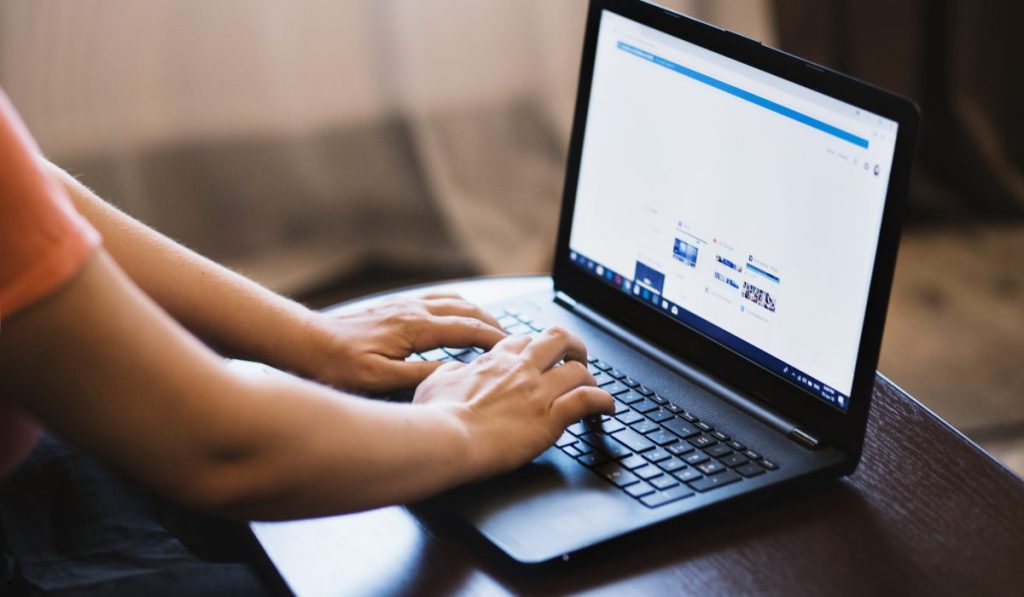Person working on a laptop to create a Probability Plot Excel chart for statistical data analysis and normality testing.