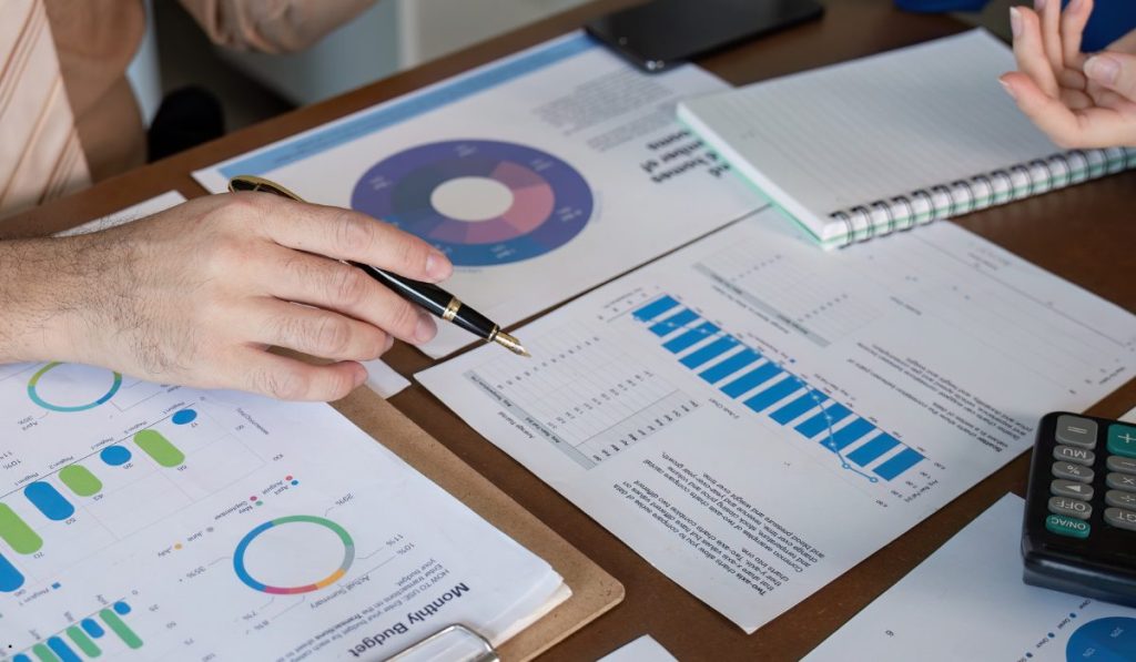 Business professionals reviewing financial reports to calculate and interpret relative standard deviation in statistical data analysis.