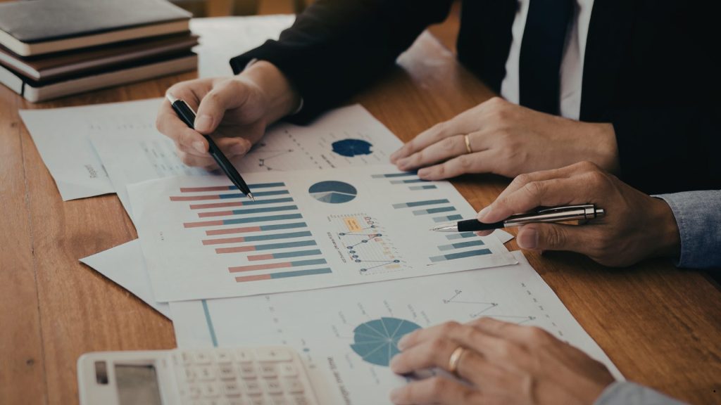 Business Process Intelligence professionals analyzing charts, KPI reports, and data visualizations to identify trends and optimize business performance.