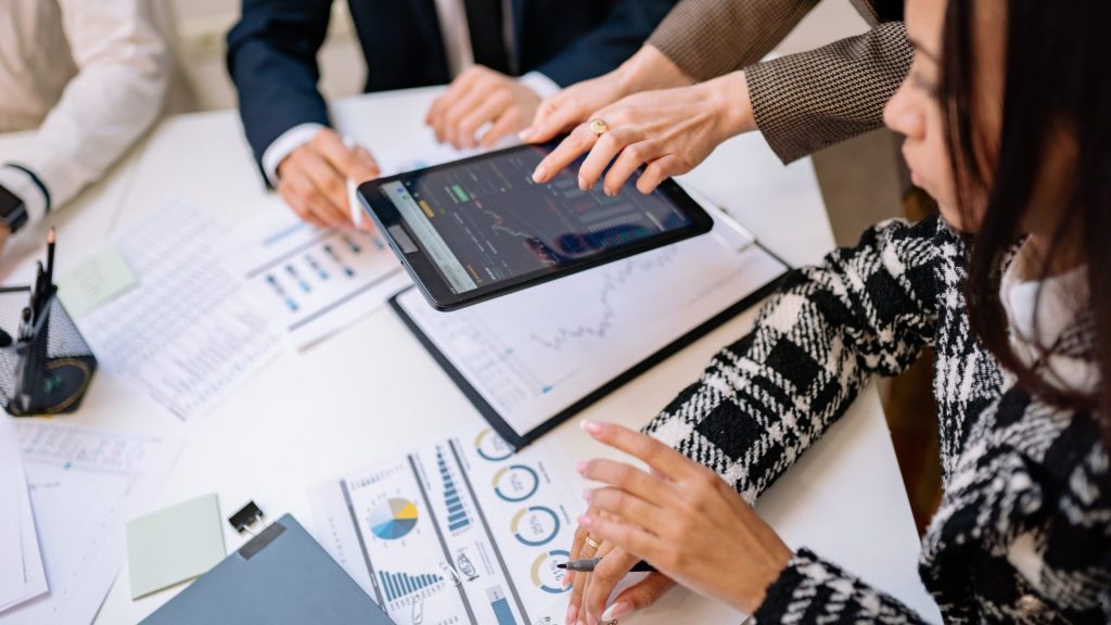 Business Process Intelligence team reviewing digital dashboards, performance metrics, and operational analytics to improve decision-making and process efficiency.