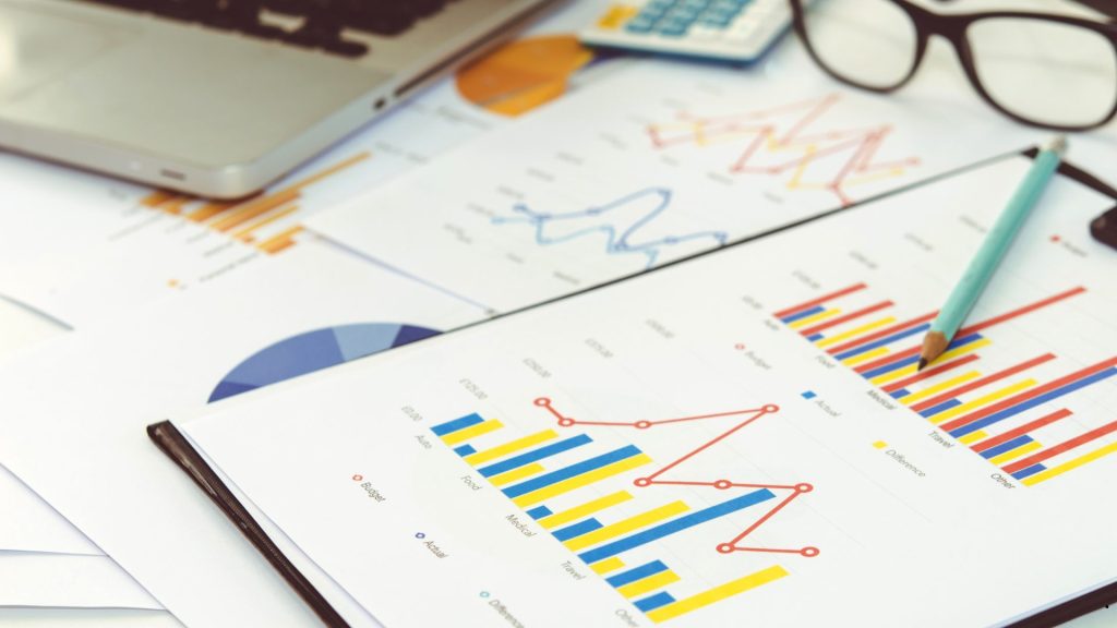 Financial reports and charts displaying Normality Statistics analysis for evaluating data distribution and statistical assumptions.