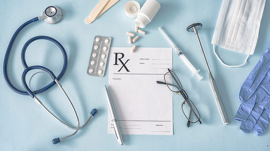 Medical tools, prescription forms, and clinical equipment representing process improvement and quality management in Six Sigma healthcare.
