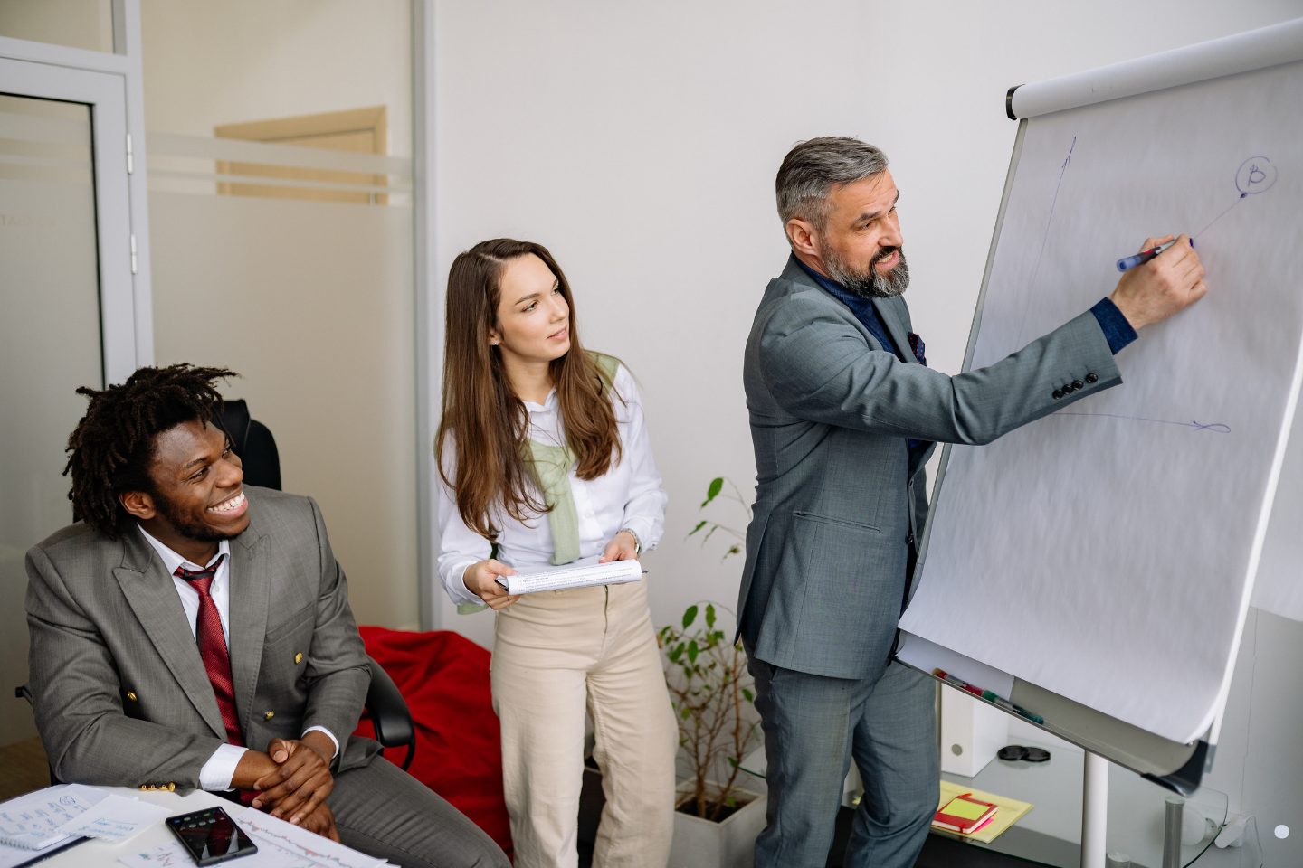 Business professionals participating in a 5S training session with visual workplace improvement and process optimization discussions.