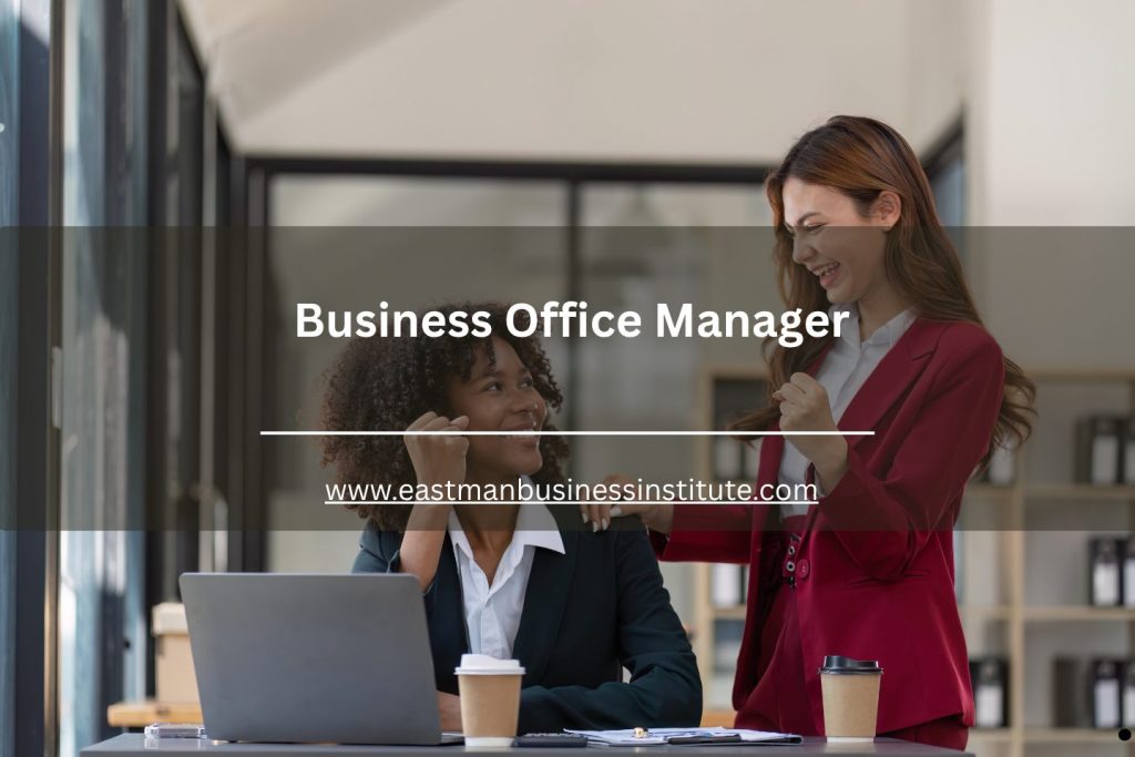Business office manager celebrating team success while working with a colleague in a modern office environment.