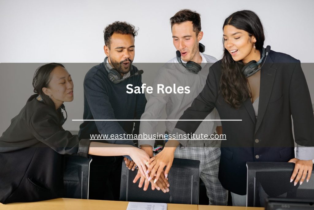 Group of employees wearing headsets stacking hands together with “Safe Roles” text overlay for the safe roles topic.