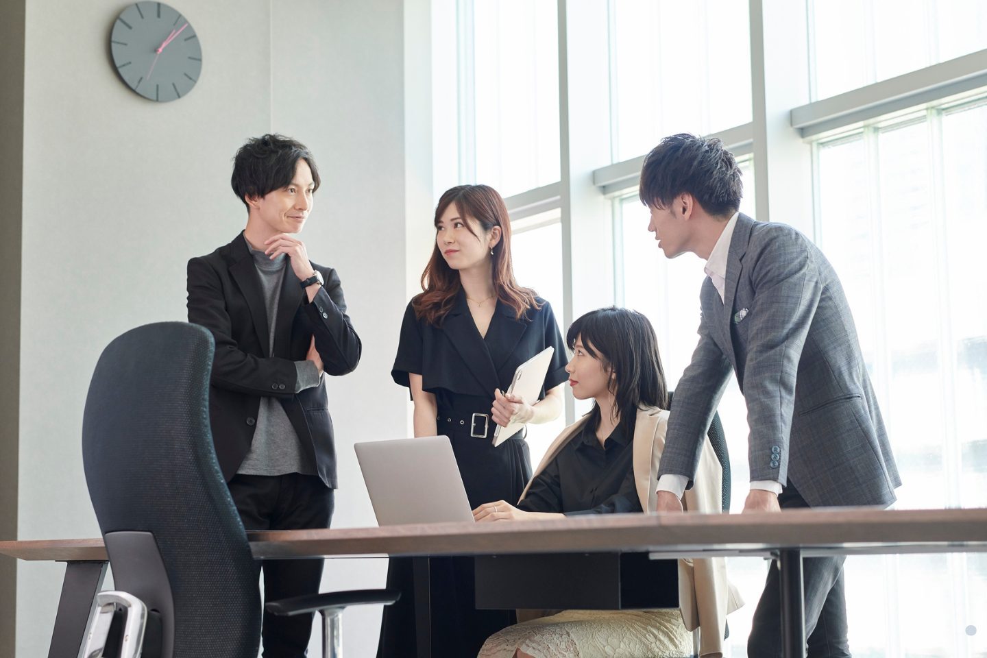 Business team collaborating on strategy and process improvement discussions in a modern office setting.