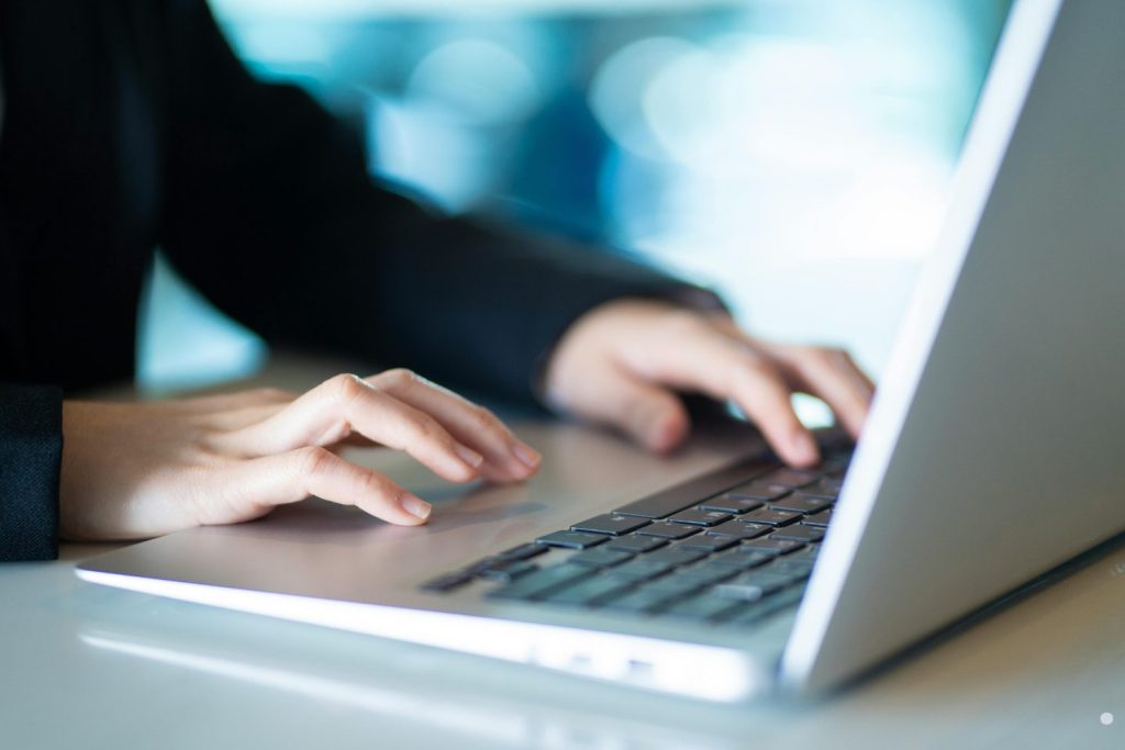 Turnaround time close-up of business professional using a laptop for fast digital workflow and task management.
