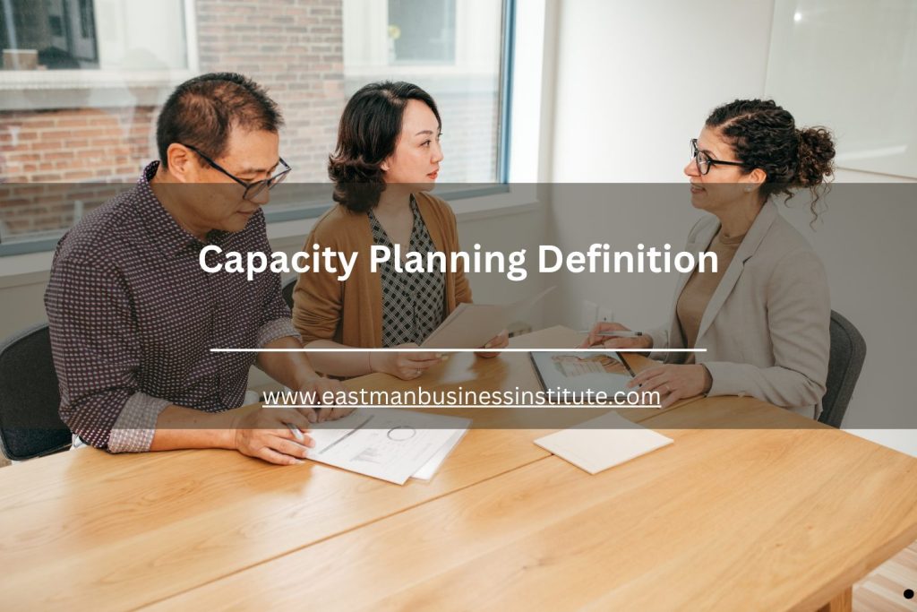 Group of professionals collaborating over documents during a capacity planning discussion.