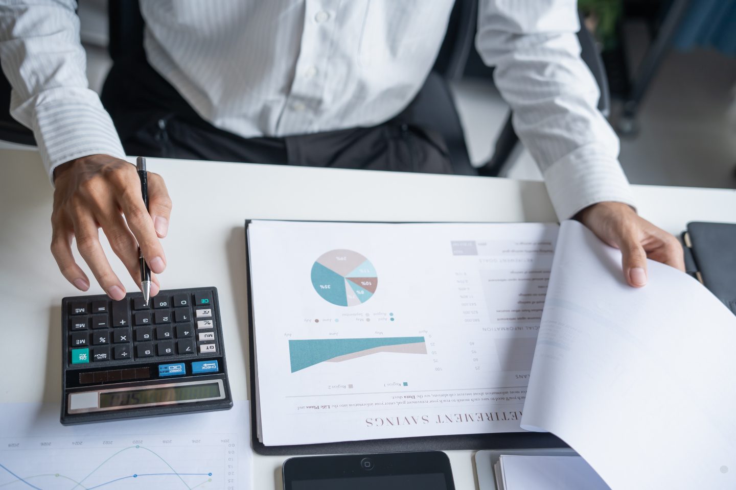 Professional reviewing financial charts and calculations for cost management in project management planning.