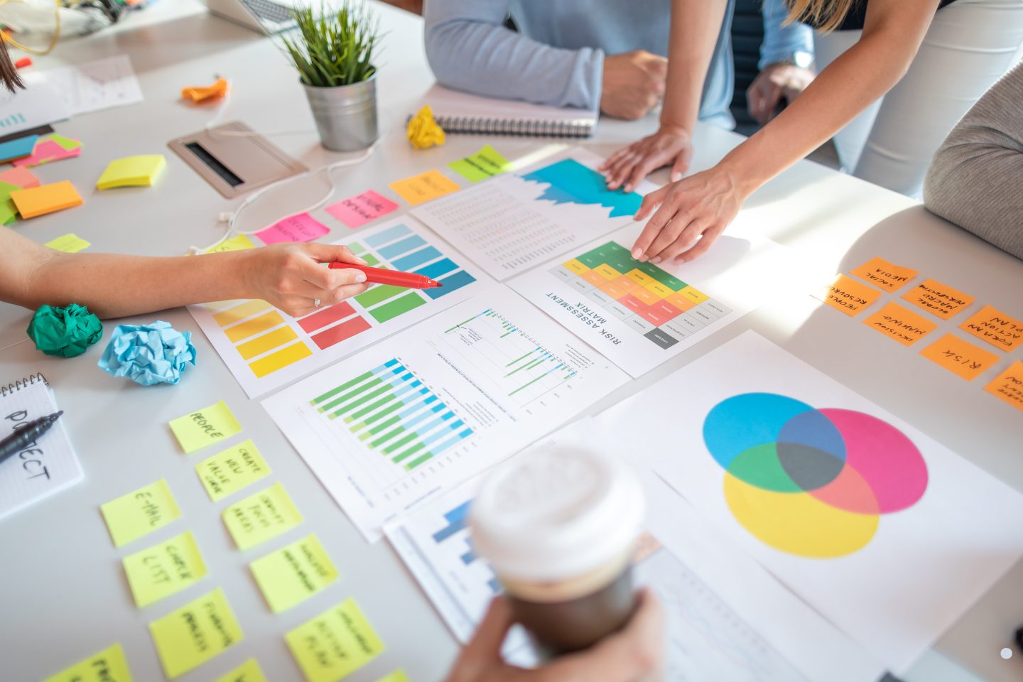 Team collaborating on colorful charts and sticky notes during a business process planning session