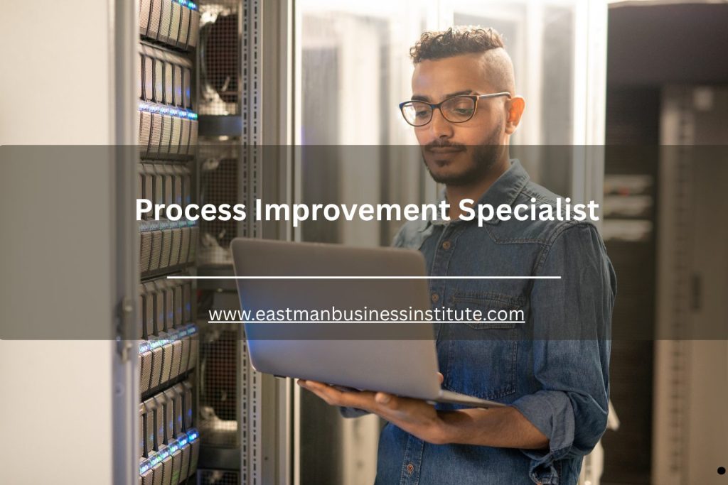 Process improvement specialist monitoring server systems and operational performance using a laptop in a data center environment.