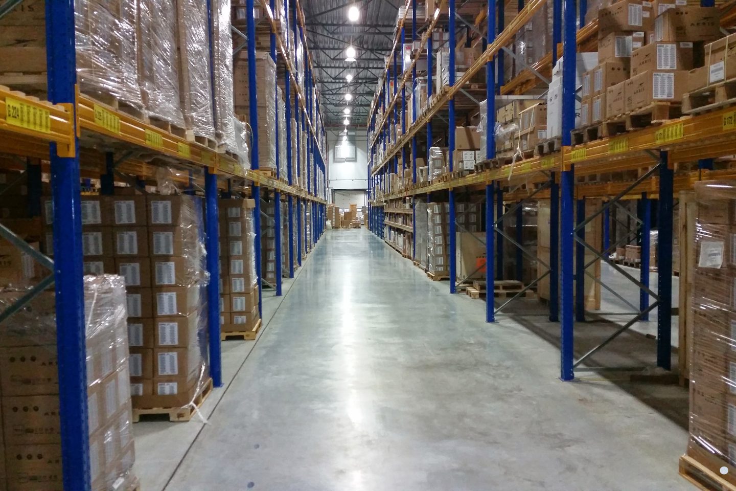 Supply chain capacity planning distribution center with organized warehouse shelving and packaged inventory management.