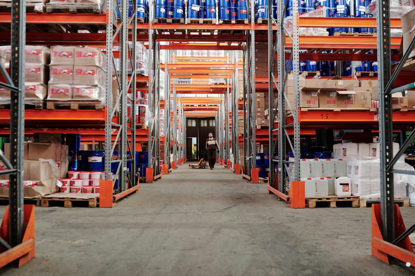 Supply chain capacity planning warehouse aisle with industrial pallet racks and inventory storage for logistics operations.